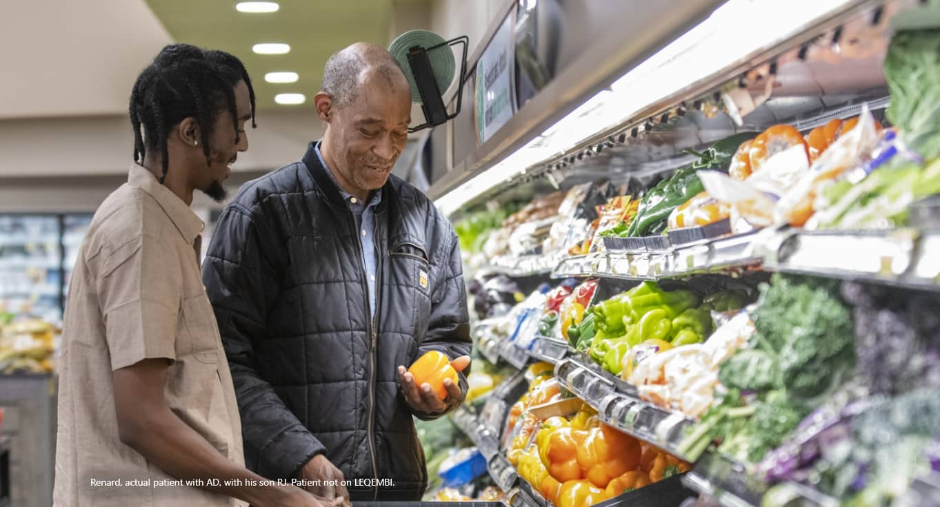 A father and adult son shopping together at a supermarket