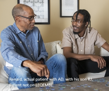 Father and adult son sitting and talking