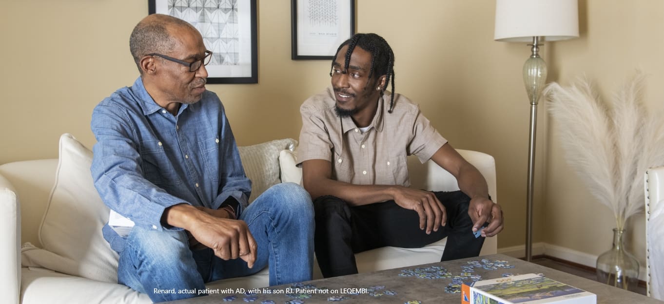 Father and adult son sitting and talking