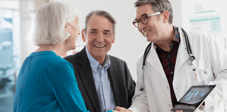 A patient and their partner talking to a healthcare provider